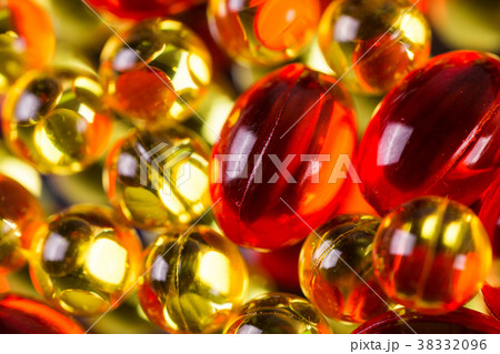 yellow and red medical capsules on a mirror 38332096