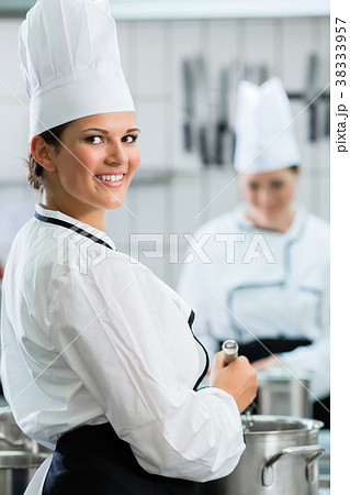 Female chefs at work in system catering 38333957