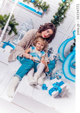 beautiful mother and charming daughter, sitting beautiful mother and charming daughter, sitting 38334771