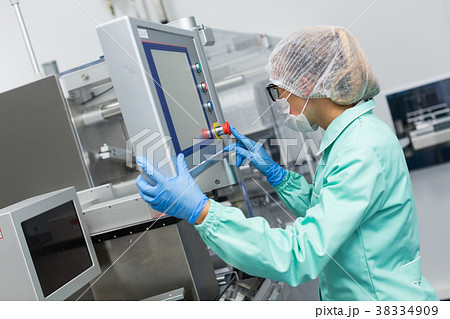 factory worker configures control panel 38334909