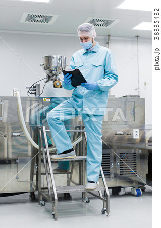 scientist work with big metal machine on ladder 38335432