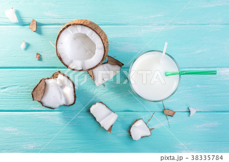 Glass of coconut milk on blue wooden table Glass of coconut milk on blue wooden table 38335784