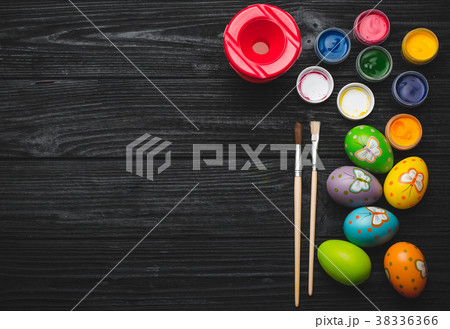 Painting eggs for Easter holiday on wooden table 38336366