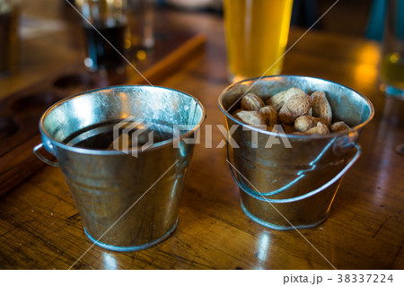 Bar buckets with raw peanuts and beer 38337224