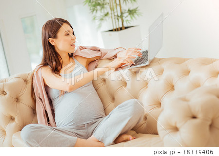 Interested busy woman sitting and using the laptop 38339406