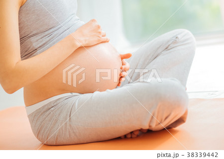Careful impregnate woman touching to her stomach Careful impregnate woman touching to her stomach 38339442
