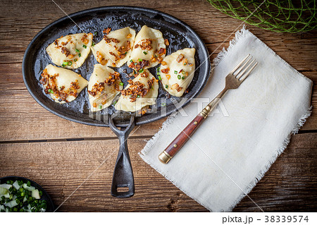 Dumplings with meat, onion and bacon. 38339574