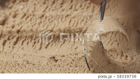 closeup hazelnut praline ice cream scooping with 38339736