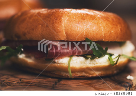two bagels with prosciutto and cream cheese on 38339991