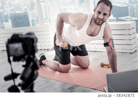 Pleased male blogger sharing his exercising for 38342875
