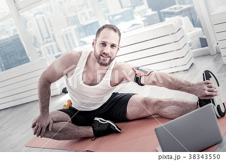 Glad handsome sportsman taking exercises 38343550