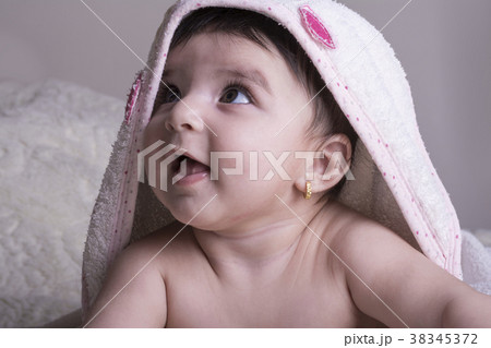 Little baby wearing white bath towel, relaxing Little baby wearing white bath towel, relaxing 38345372