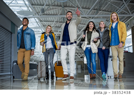 Pleased company with baggage arriving in the Pleased company with baggage arriving in the 38352438