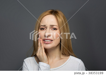 Sad young woman having toothache Sad young woman having toothache 38353199