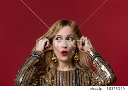 Surprised woman donning toys on ears 38353349