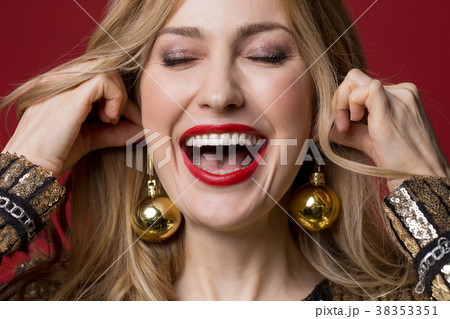 Optimistic girl wearing christmas tree decorations 38353351