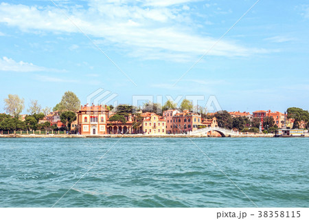 Daylight view to blue water, small bridge and city 38358115