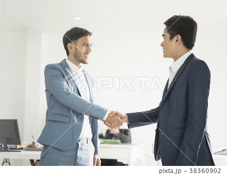 Businessmen making handshake agreement.  38360902