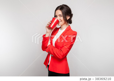 Picture of attractive woman in red dress with cup 38369210