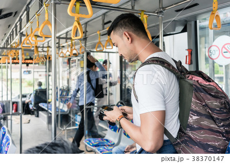 Young male tourist using the mobile phone Young male tourist using the mobile phone 38370147