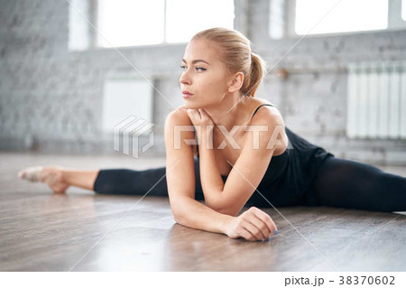 Slim thoughtful woman stretching her body in the 38370602