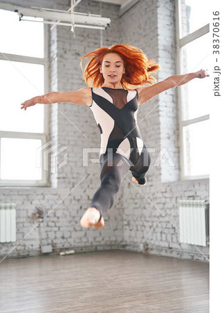 Young sport woman gymnastics doing jumping 38370616
