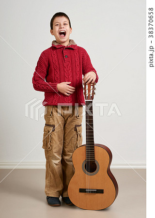 Boy is playing the acoustic guitar 38370658