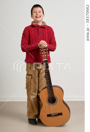 Boy is playing the acoustic guitar 38370662