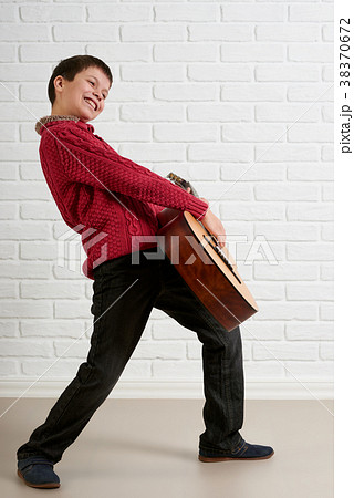 Boy is playing the acoustic guitar Boy is playing the acoustic guitar 38370672
