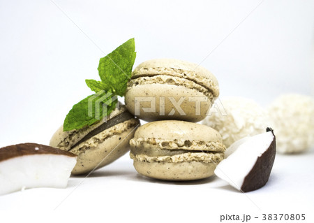 Macaroons with fresh coconut, mint leaves on white Macaroons with fresh coconut, mint leaves on white 38370805