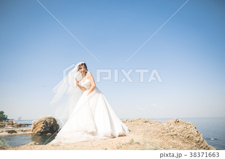 Romantic beautiful bride in white dress posing on 38371663