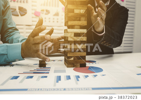 Business man and woman stop wood tower Business man and woman stop wood tower 38372023