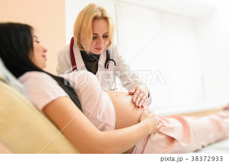 Doctor listen tummy of pregnant woman Doctor listen tummy of pregnant woman 38372933
