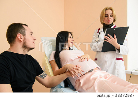 Male holding his pregnant wife hands Male holding his pregnant wife hands 38372937