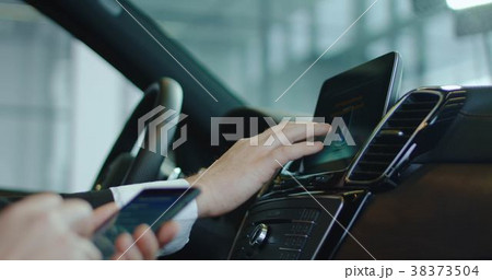 Two people testing on-board computer in car 38373504