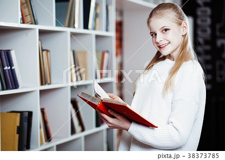 Teenage girl in a library Teenage girl in a library 38373785