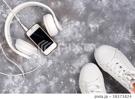 Flat lay Of White Sneakers On stone Background 38373824