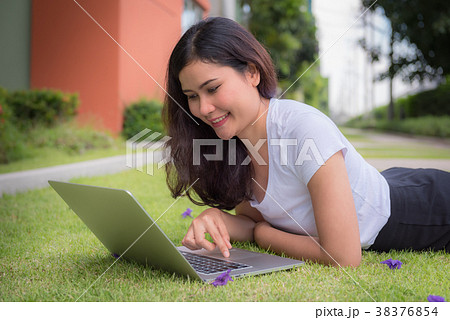 Asian woman lying on the grass Asian woman lying on the grass 38376854