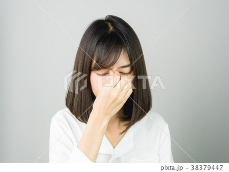 woman is touching face between the eyebrows. 38379447