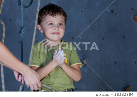 little boy and mother standing near a climbing  rock wall indoor little boy and mother standing near a climbing  rock wall indoor 38382384