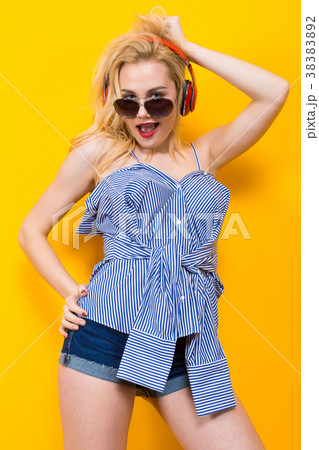Girl in blouse with headphones and sunglasses 38383892