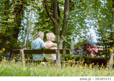Romantic elderly couple sitting together on a 38385435