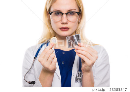 Woman doctor with stethoscope hold condom Woman doctor with stethoscope hold condom 38385847