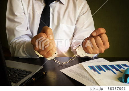 Businessman in handcuffs. White collar crime. Businessman in handcuffs. White collar crime. 38387091