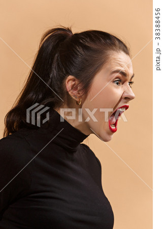 The young emotional angry woman screaming on The young emotional angry woman screaming on 38388456