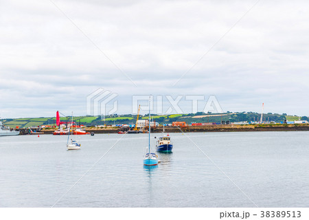 Boats and ships moored in a small port Boats and ships moored in a small port 38389513