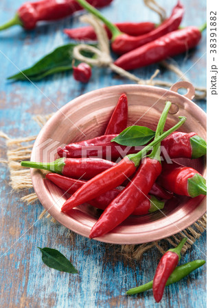 Chili peppers in a copper pot 38391882