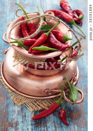 Chili peppers in a copper pot 38391884