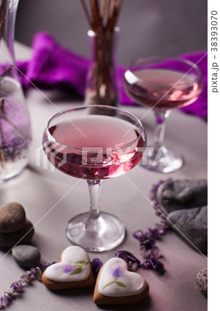 A magical lilac drink in a mysterious evening sett 38393070