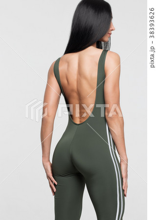 Slim tanned woman body over gray background 38393626
